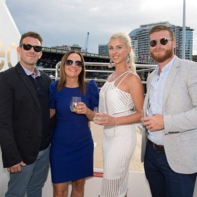 a person standing in front of a group of people posing for the camera