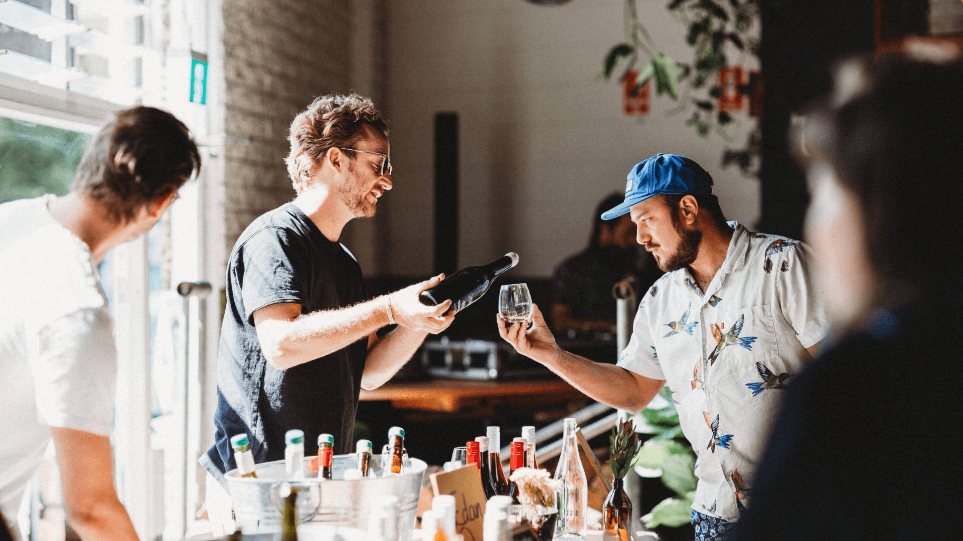 a couple of people standing around a table
